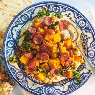 Hummus bowl with chorizo and crispy kale